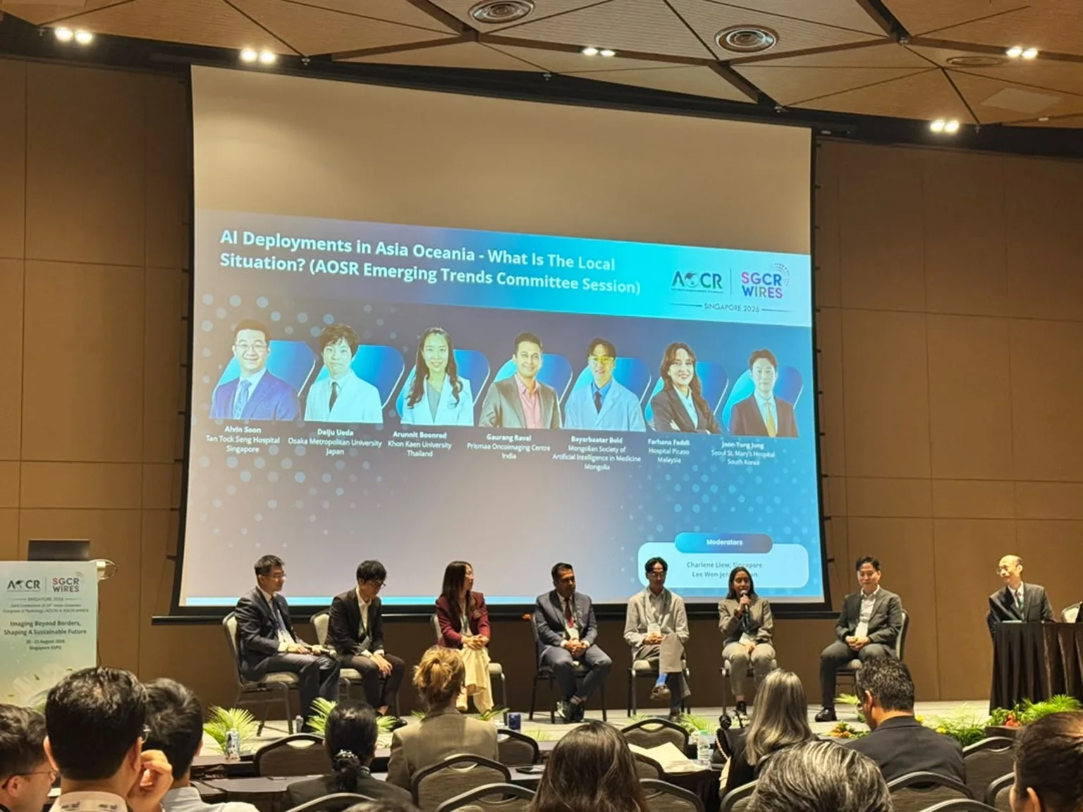 Dr Farhana Fadzli seated on an AOCR 2026 panel beneath a slide about AI deployment in Asia Oceania